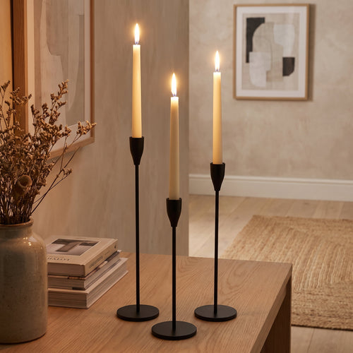 Black taper candlesticks lit on an oak console in a warm sitting room, Style Room