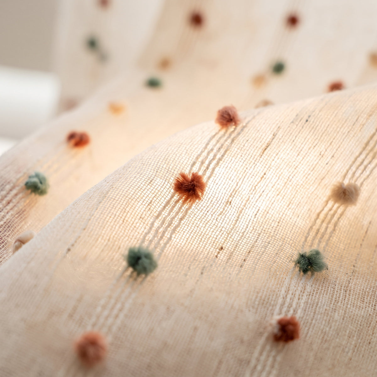 Close-up of the pom-pom tufts on the Sable tulle curtain, Style Room