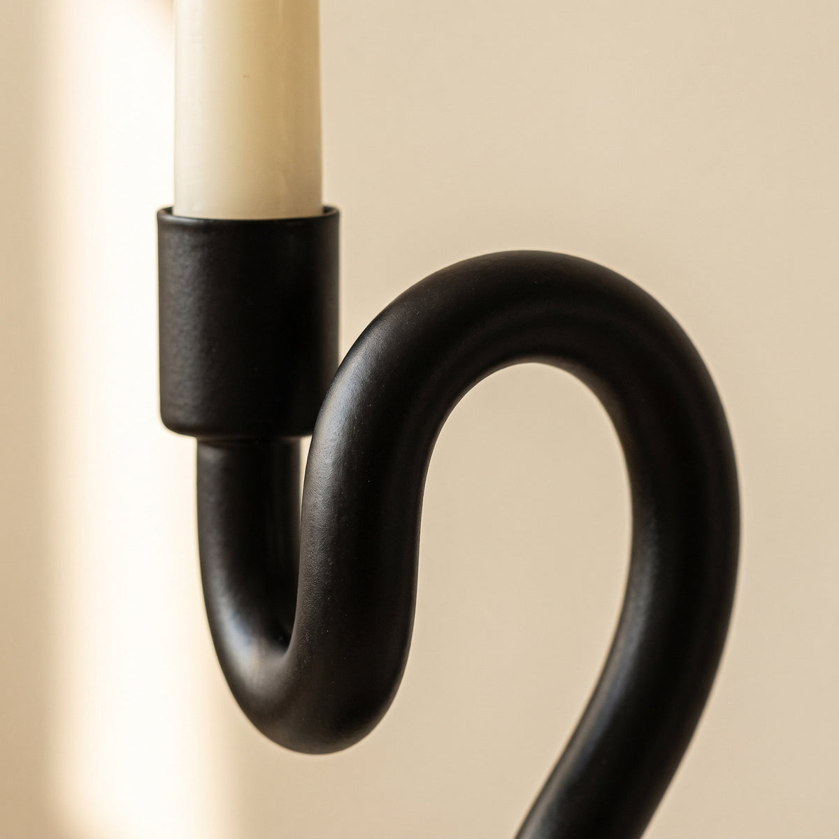 Close-up of the candle cup and wavy stem of the Sable iron candle holder, Style Room