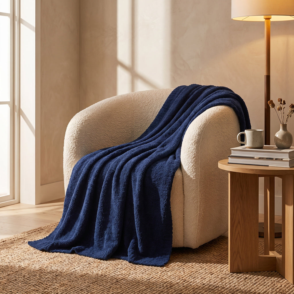 Seren navy knitted throw draped over a cream boucle armchair, Style Room