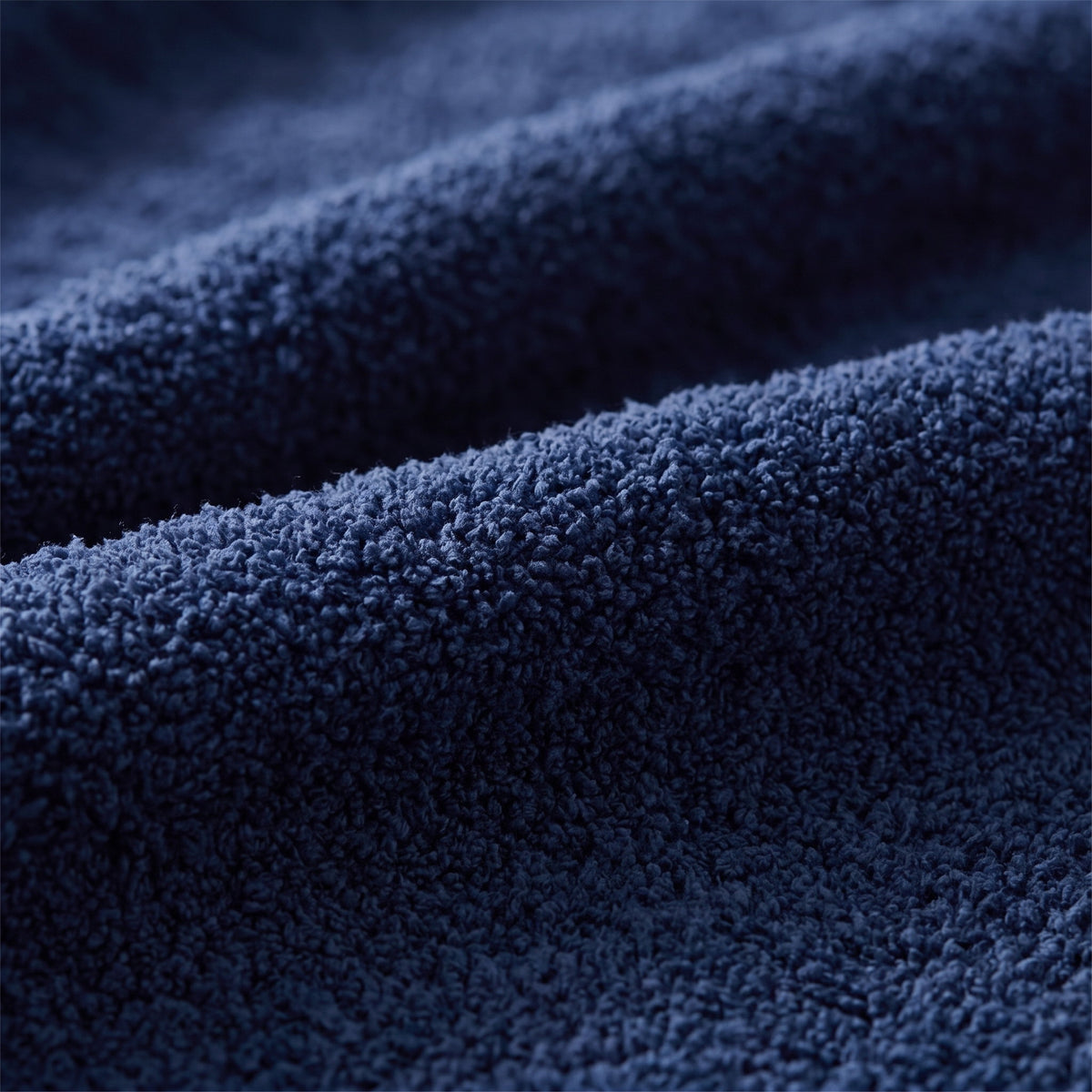 Close-up of the soft knit texture of the Seren navy throw, Style Room