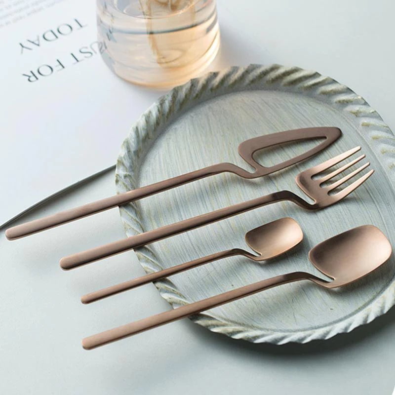 Sierra cutlery set in rose gold on a ridged ceramic plate