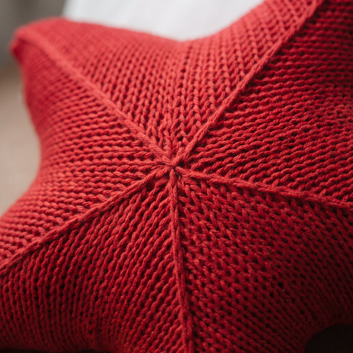 Close-up of the knitted centre of the Silky star cushion, Style Room