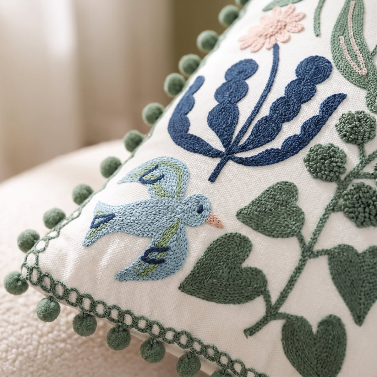 Close-up of the bird and floral embroidery on the Vera cushion, Style Room
