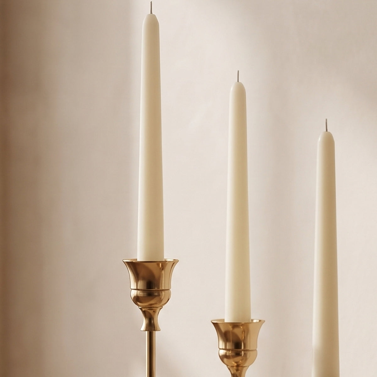 Detail of the Vero brass candle holders showing the fluted tulip cups and slim turned stems