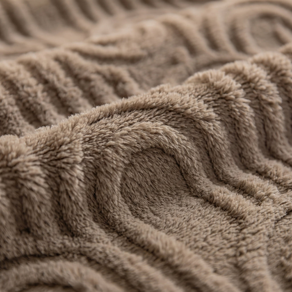 Close-up of the carved arch relief of the Viora plush blanket, Style Room