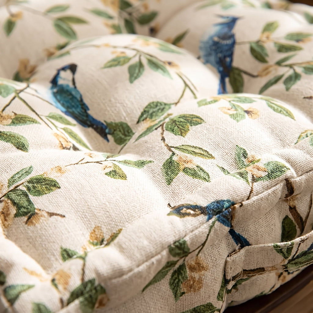 Close-up of the leaf and bird print and tufted stitching on the Wren cushion, Style Room