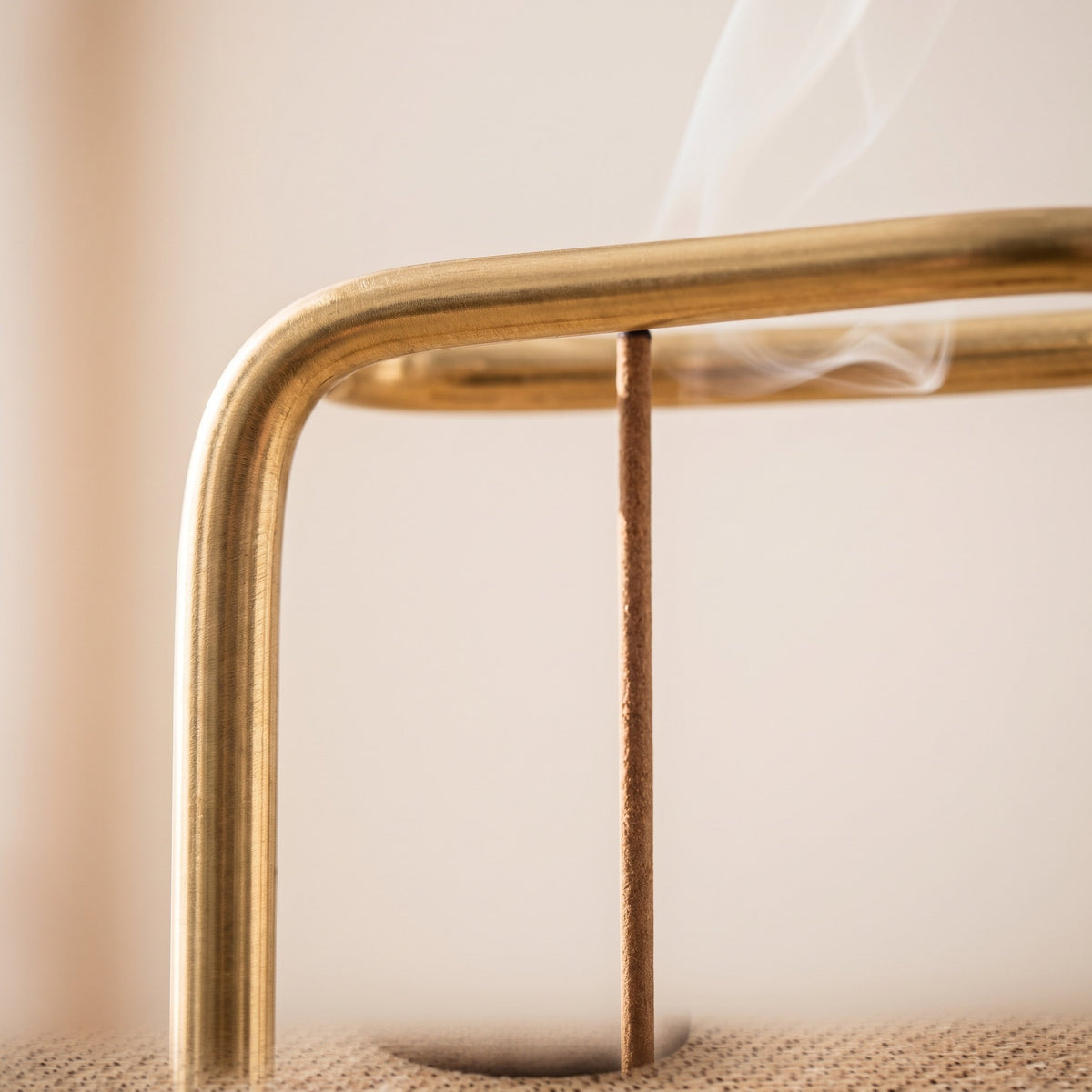 Close-up of the brass arm and hanging incense stick of the Wren burner, Style Room