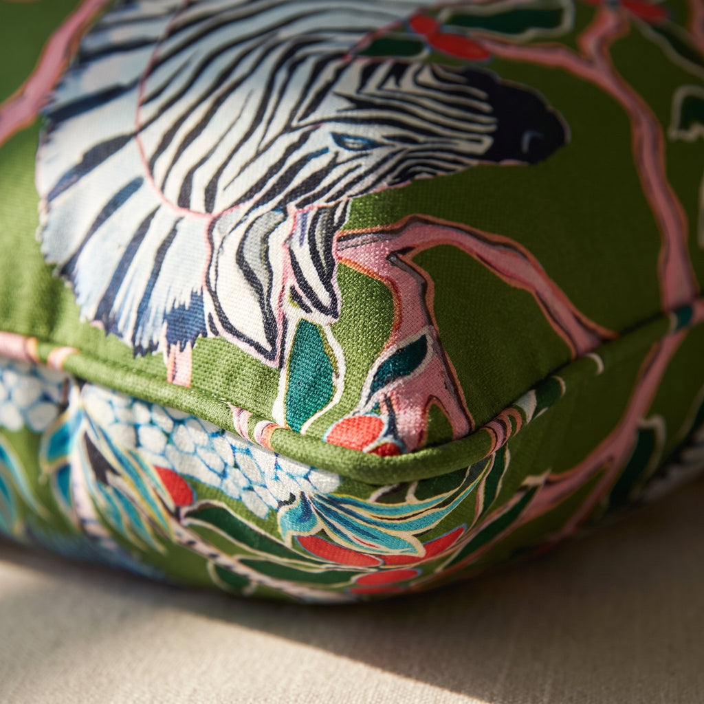 Detail of the Zara cushion corner showing the zebra print on the green botanical microfiber ground