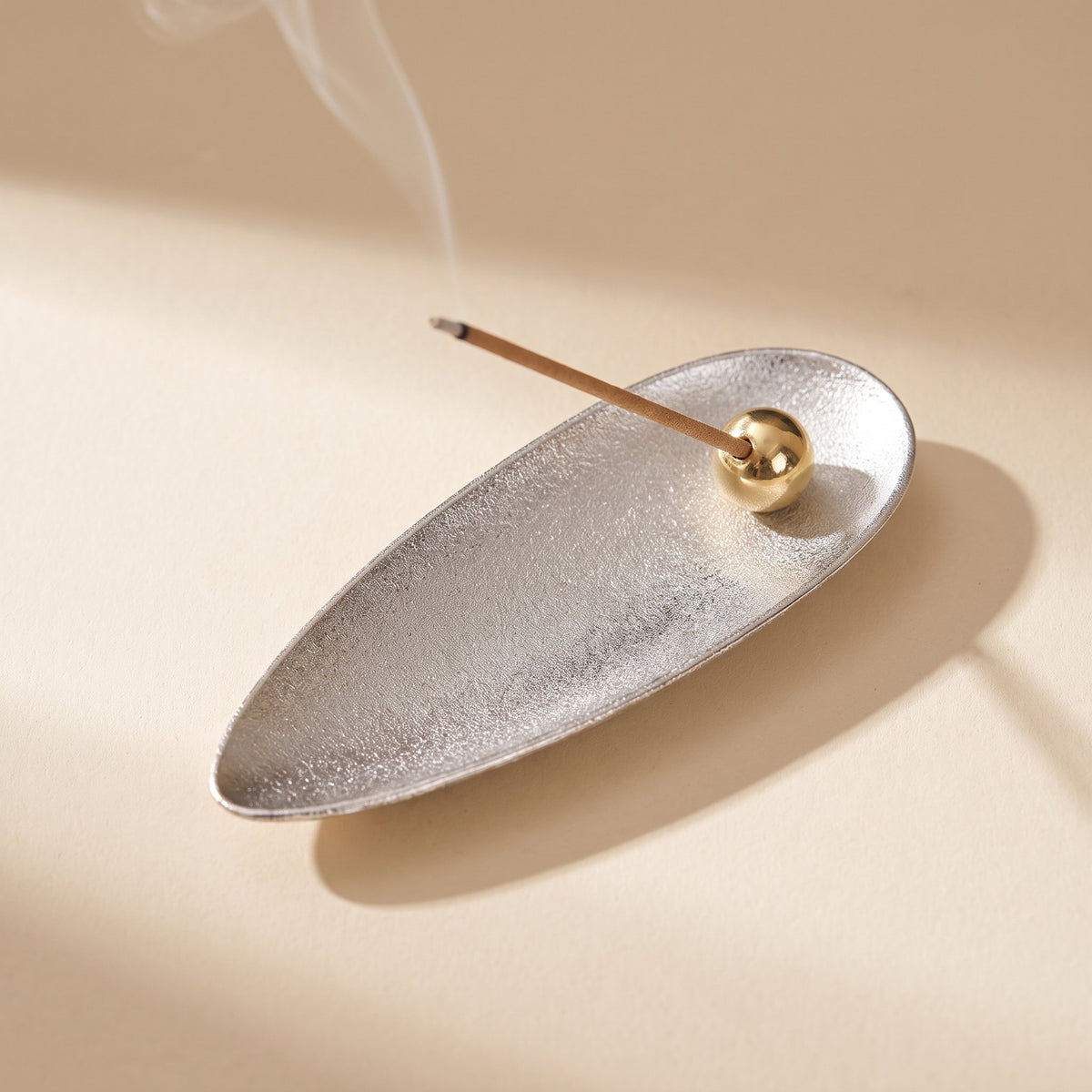 Zento incense holder in brushed silver alloy, leaf shape with a brass bead, Style Room
